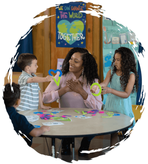 Teacher receiving a heart cut out from her pre-k children