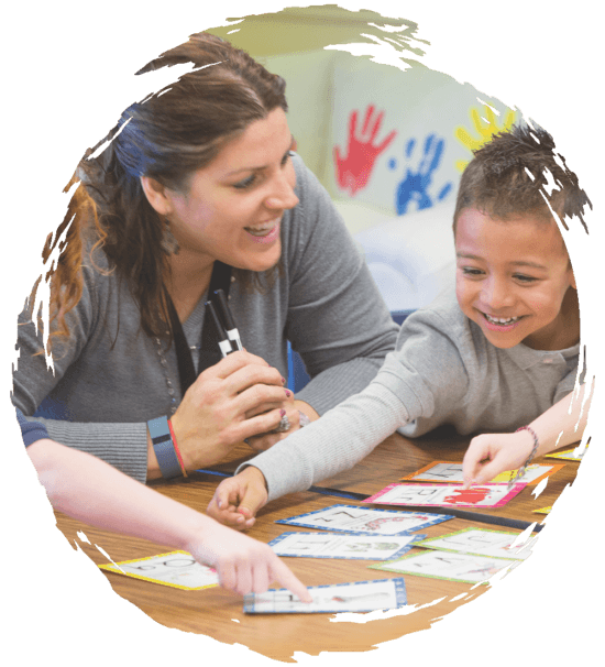 Teacher using play cards with preschoolers