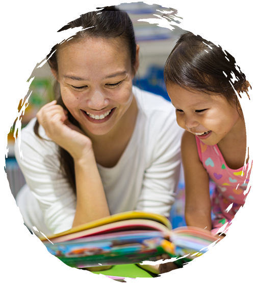 Teacher enjoying a book with a young child