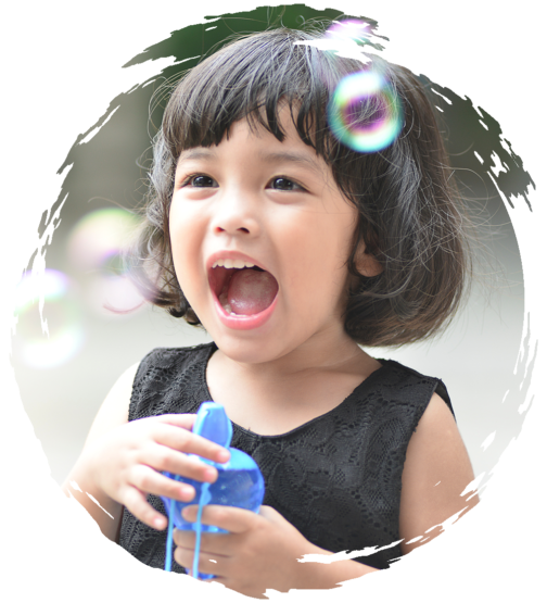 Young girl blowing bubbles and smiling